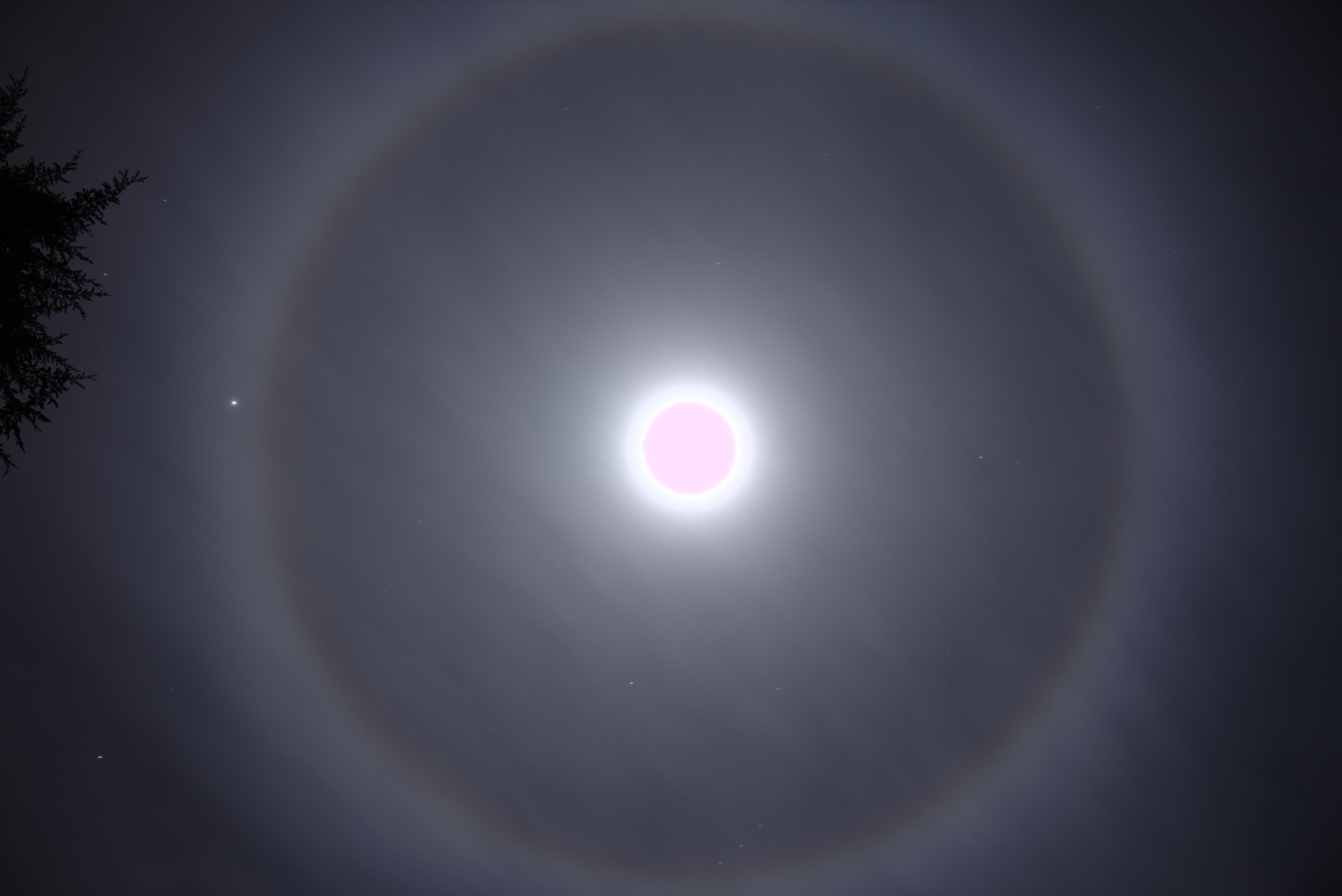 What causes halos ring around the sun or the moon Update